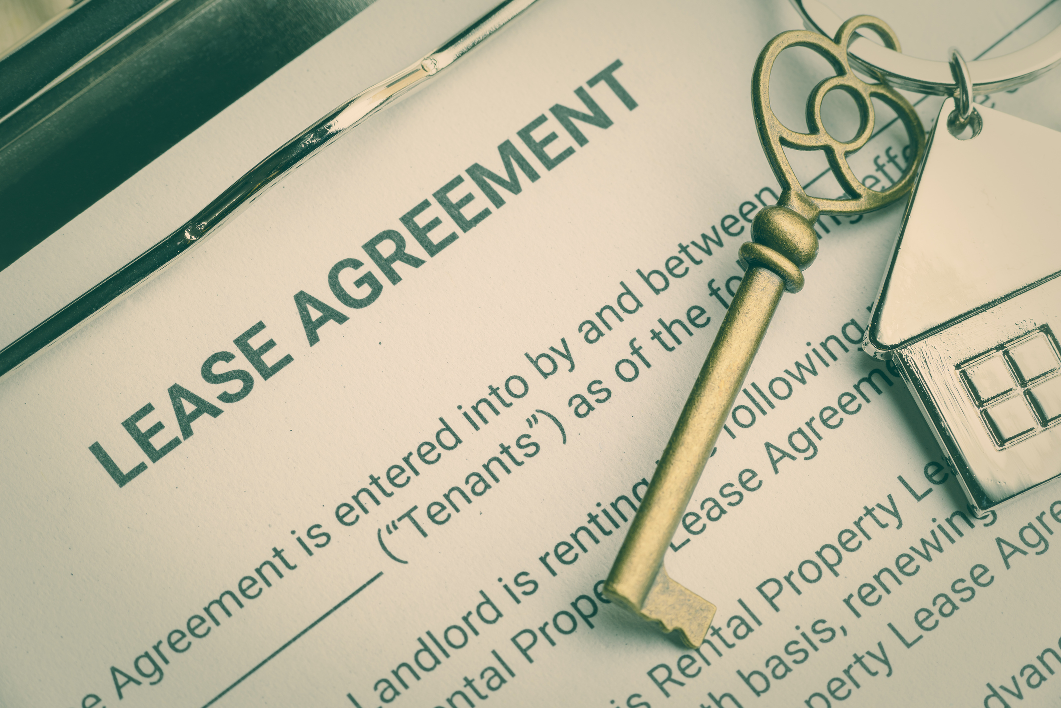 Business lease agreement concept : Keychain on a lease agreement form. Lease agreement is a contract between a lessor and a lessee that allow lessee rights to use of a property owned by lessor Residential tenant lease agreement affected by compulsory acquisition in NSW