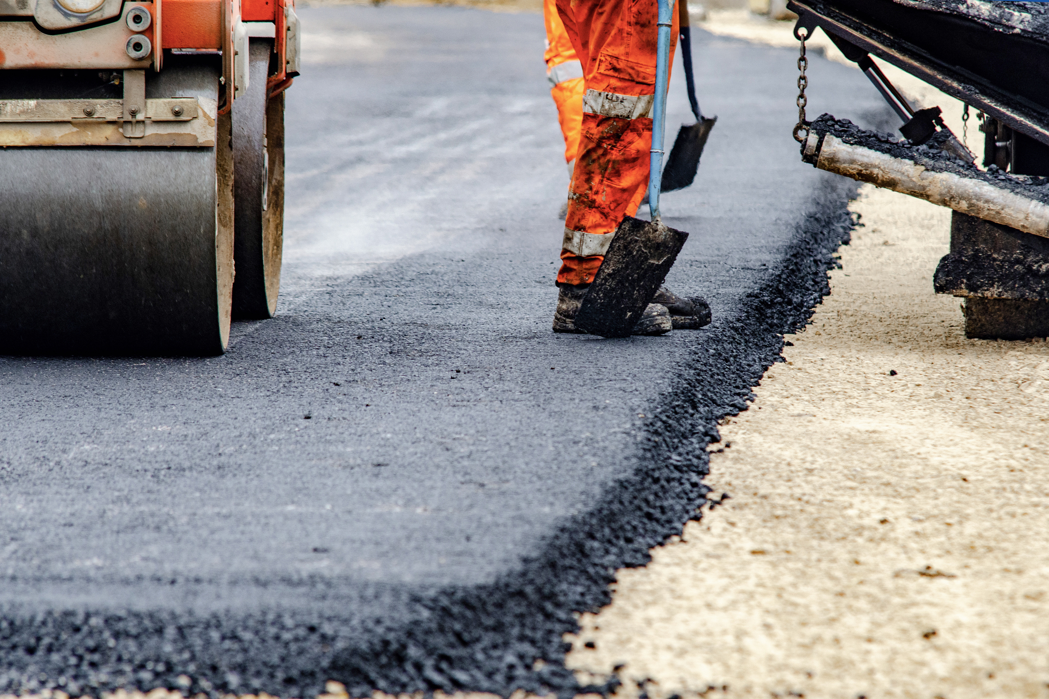 Elizabeth Drive upgrade Road workers laying asphalt during road upgrade works